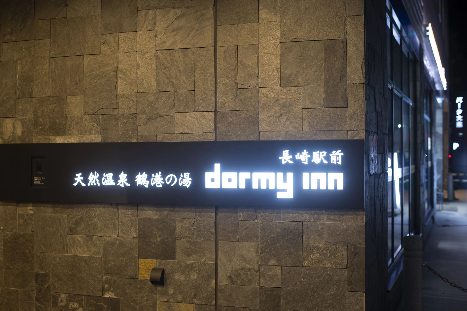 ドーミーインPREMIUM長崎駅前 — 長崎市五島町 · 「長崎駅前」を掲げる館銘板、11階に天然温泉大浴場